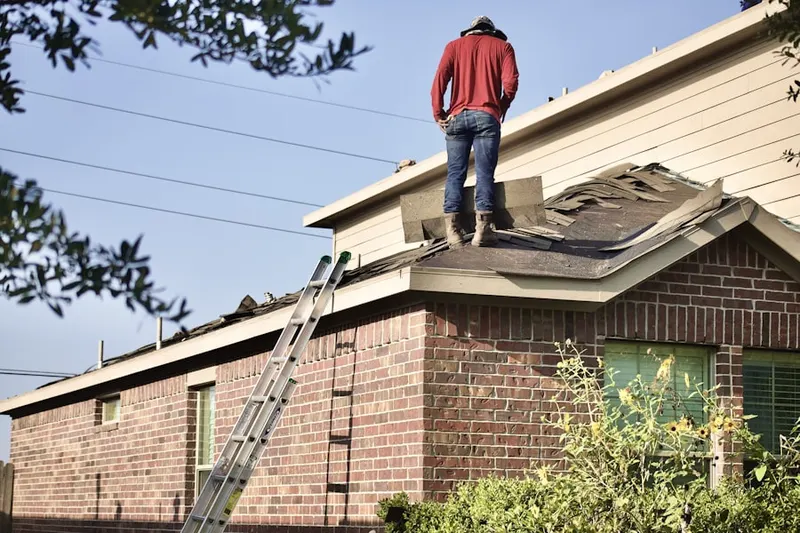 Professional roofer working on a residential roof in Belleville
